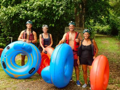 Adventurous travelers floating through a cave system on tubes in the Belizean jungle